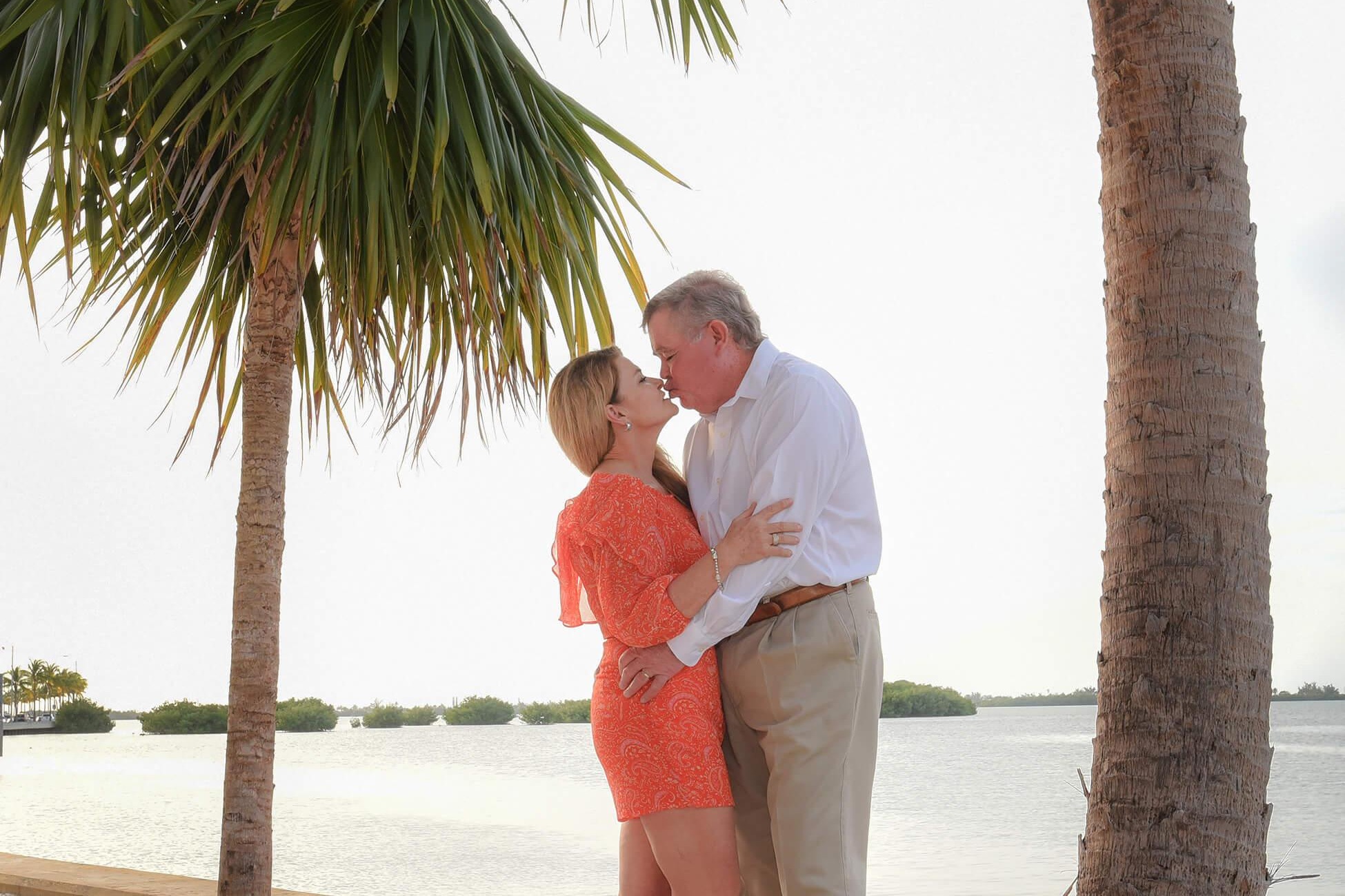 Couple portrait under palm trees
